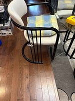 Side view of chair and portion of glass table