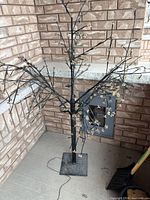 Full view of lighted tree showing structure and cord