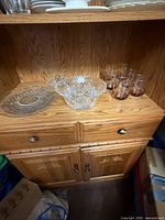 Cut glass bowl, pressed glass platter and six amber swirl tumblers on bottom shelf