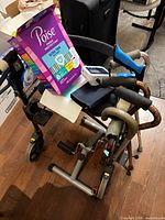 Overall view showing rollator walker, three canes, BP monitor, Poise pads box and underpads