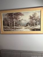 Front view of framed oil landscape painting on wall