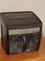 Front view showing Staples MailMate shredder with transparent bin and power cord