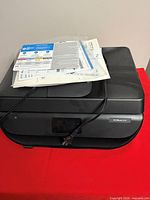 Top view of HP OfficeJet 5255 printer with manuals on lid