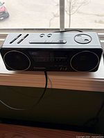 Front view of Panasonic digital clock radio with speakers, display and controls