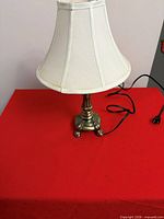 Small table lamp with ivory fabric shade and brass-tone base