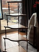 Full view showing five wooden shelves and spindle supports