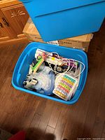 Overall view of blue tote and contents on floor