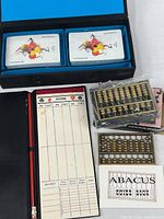 Full contents: case with two card decks, scorepad, pencils, two abacuses (one boxed)