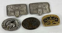 Group shot of five belt buckles