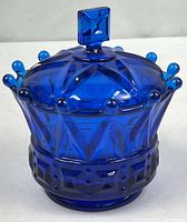 Full view of cobalt blue covered candy dish showing beaded rim and diamond-point base