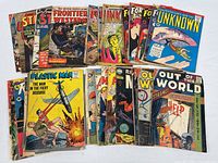 Group shot of all 32 comics spread out showing variety of titles and cover conditions