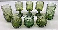Group shot of all nine avocado green bark-textured glasses