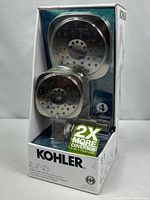 Front of sealed box showing dual showerheads, Kohler branding