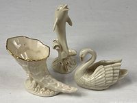 Group shot of dolphin, swan, and shell figurines