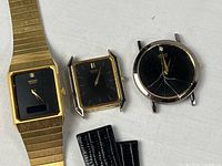 Three Seiko Quartz watches showing cases, dials, metal bracelet, cracked crystal, and loose leather strap