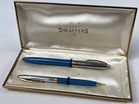 Pen and pencil inside open Sheaffer box