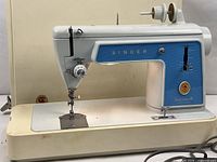 Front view of Singer 604E sewing machine on base