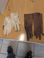 Both pairs of gloves side by side on table