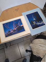 Both matted prints displayed side by side on table