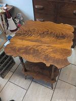 Full view of two-tier mahogany table showing shape and tiers