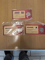 All three team-branded Super Bowl commemorative coins in packaging