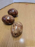Three marble eggs on tabletop