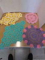Group shot of four assorted crocheted doilies