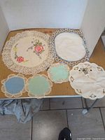 All five doilies laid out showing sizes and designs