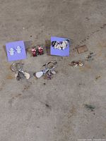 Overview of all six earring pairs on floor