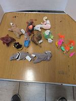 Group view of all Ty Teenie Beanie Babies plush and troll dolls on tabletop