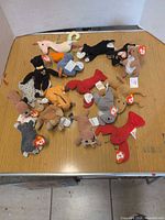 Group of approximately 17 small Ty Teenie Beanie Babies plush animals on tabletop