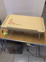 Top view of cream painted folding tray with floral motif