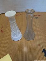 Milk glass and clear glass bud vases side by side