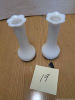 Front view of both milk glass bud vases showing shape and size