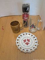 Group of two Centennial mugs, plate and toy soldier