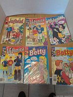 Group shot of all six Archie comics displayed on table