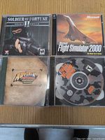 All four PC game jewel cases and discs visible