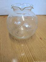 Front view of clear etched glass rose bowl showing ruffled rim and floral design