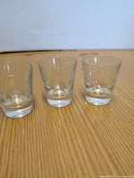 Front view of three etched shot glasses