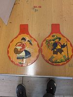 Both wooden paddles front view