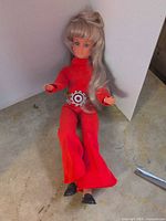 Full doll sitting, showing outfit and shoes