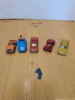 Five toy cars lined up