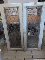 Front view of both hinged leaded glass windows