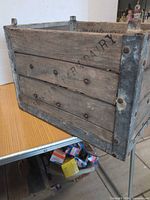 Overall view of wood and metal milk crate