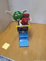 Front view showing entire dispenser with characters and logo