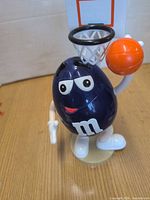 Full view of M&M's basketball dispenser showing character, hoop and base