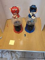 Front view of both red and blue M&M's dispensers