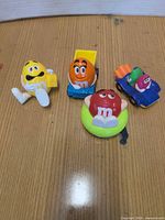 All four M&M character toys on tabletop