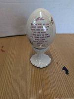 Full view of decorative ostrich egg on stand