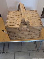 Full view of rectangular woven bamboo picnic basket on table